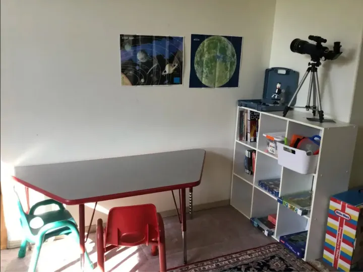 Learning corner with telescope, star maps, and books at Angel Family Daycare